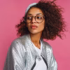 close-up-fashion-portrait-mix-race-woman-with-brown-skin-curly-african-hairstyle-vivid-pink-background-wearing-silver-winter-jacket-grey-hat_273443-104