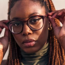 vertical-close-up-portrait-young-black-woman-putting-her-glasses-looking-camera-concept-youth-racial-diversity_362480-1141
